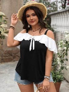 Detail showing off-the-shoulder ruffle sleeves and bowtie on black plus size top