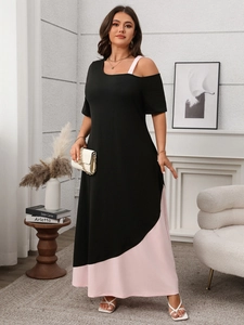 Detail of plus size black and pink contrast dress with asymmetric cold shoulder design