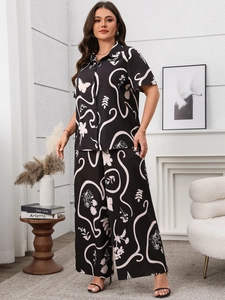 Cozy indoor scene featuring two-piece loungewear with abstract white print on black fabric