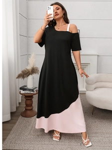 Detailed view of color-block dress with asymmetric cold shoulder and pink hem contrast
