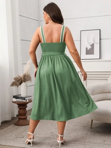 Detail of green backless maxi dress featuring elastic shirring and vertical texture