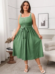 Detail view of green midi dress with lace square neck and drawstring waist design