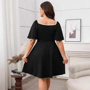 Women's plus size black A-line dress with square neck and contrast white trim detail