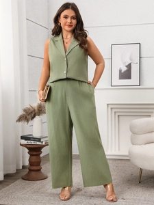 Detail of olive green linen vest and wide-leg trousers set in an elegant home interior
