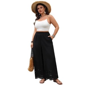Women's black high-waisted wide-leg trousers with laser-cut hollowed lace hem detailing
