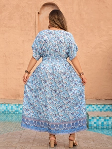 Back view of bohemian maxi dress featuring floral print and elastic waist detail