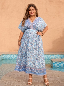 Detailed view of the V-neck and boho floral print on this blue plus size maxi dress