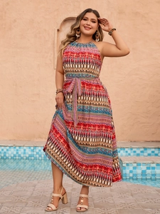 Detail of bohemian halter neck maxi dress with vibrant ethnic print and waist tie belt