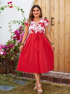 Detail of red floral print V-neck dress with a waist bow tie and A-line skirt