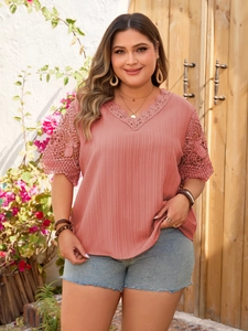 Detail of V-neckline with hollow lace embroidery on a pink plus size summer tunic top