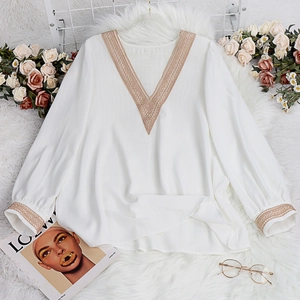 Elegant white V-neck long sleeve shirt featuring delicate lace stitching on fluffy background