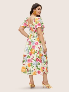 Detail of square neck floral maxi dress with smocked back and vibrant flower patterns