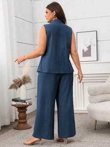 Detail view of the back silhouette on a navy blue sleeveless top and wide-leg trousers set