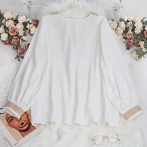Elegant white V-neck long sleeve shirt featuring intricate lace embroidery and pleated fabric