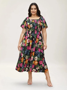 Close-up of smocked bodice and square neck detail on floral plus size midi dress