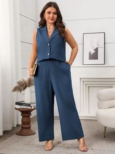 Detail of dark blue sleeveless vest set with high waist wide leg trousers on a model