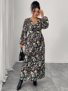 Detailed view of the V-neck and delicate floral print on a black long sleeve maxi dress