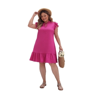 Pink plus size summer dress with ruffle sleeves and tiered hem on white background
