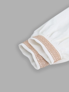 Detail of white blouse sleeve with exquisite champagne lace crochet embroidery cuff
