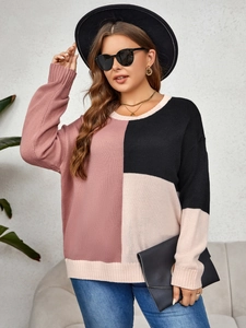 Close-up of pink, black, and beige color-block knitted sweater with fine texture details