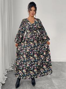 Detail of V-neck floral maxi dress featuring puff sleeves and high waist floral pattern