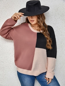 Detail of color block knit sweater featuring chunky rib cuffs and soft texture