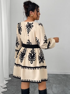 Detail of high waist ethnic pattern dress with balloon sleeves and elastic waist band