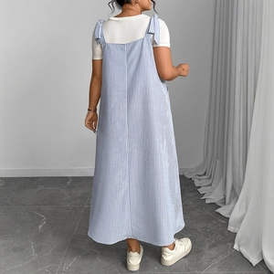 Blue and white striped pinafore dress with tie straps shown from a back view