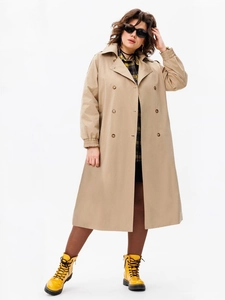 Detail of khaki double-breasted trench coat featuring elastic cuffs and amber buttons