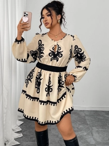 Detail of bohemian cream mini dress with ethnic embroidery and keyhole neckline