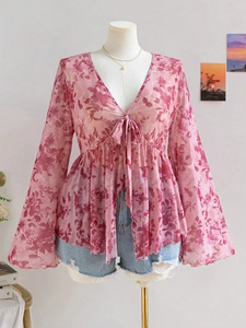 Detail of pink floral V-neck chiffon top with flared sleeves and drawstring waist