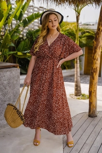 Détail d'une robe longue rouge brique à fleurs avec col en V et manches à volants