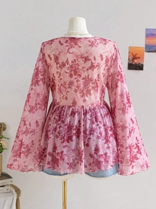 Macro detail of pink floral mesh top with elegant bell sleeves and rose print design