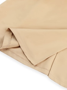 Detailed close-up showing the neat hemline and high-quality stitching on a khaki trench coat