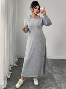 Detail of grey hooded long dress with drawstring and textured knit fabric on model