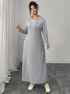 Detail of grey hooded knit dress showing the drawstring hood and soft fabric texture