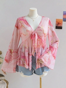 Close-up of pink marble print mesh blouse with deep V-neck and flared sleeves
