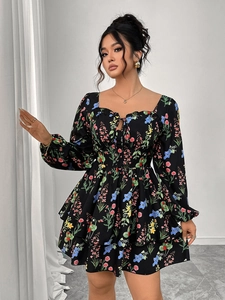 Detail view of square neckline with lace-up tie on a black floral tiered mini dress
