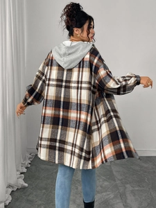 Detail view of oversized plaid shirt jacket featuring a grey drawstring hood from behind