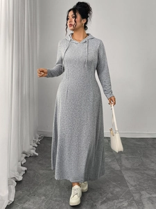Detail view of a gray hooded long sleeve dress with waist tie and pleated skirt design