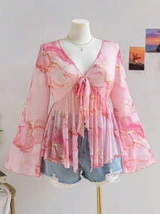 Detail of V-neck sheer mesh top with pink marble print and bell sleeves on a mannequin