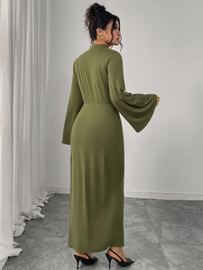 Detail of elegant olive green maxi dress with flared sleeves and a slim fit silhouette