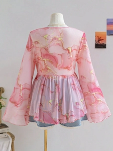 Detail view of pink marble print mesh top with flowy flare sleeves on a mannequin