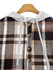 Detail of wooden buttons and grey drawstring hood on a plaid checkered autumn jacket