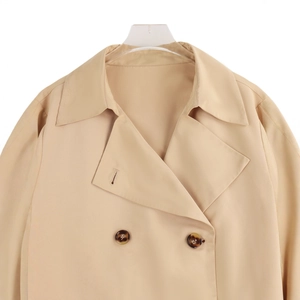 Classic beige double-breasted trench coat with notched lapels and marble texture buttons