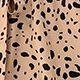 Detailed macro view of khaki and black leopard print pattern on lightweight woven fabric