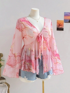 Detail of V-neck mesh top featuring pink marble print and stylish tie-front drawstring