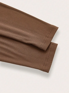 Close-up of dark brown ribbed knit fabric with precise double-needle hem stitching detail