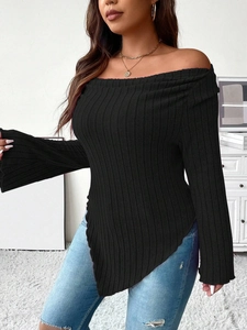 Detail of black ribbed knit off-shoulder top featuring an asymmetrical pointed hemline