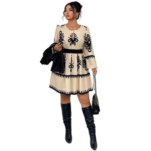 Long sleeve cream mini dress with ethnic embroidery and wide black elastic waistband